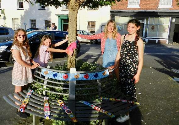 Jessica, Amy, Hayley (mum) and Miriam helped to decorate the town square during the yarn bombing to raise awareness of food poverty. NP 310519 02