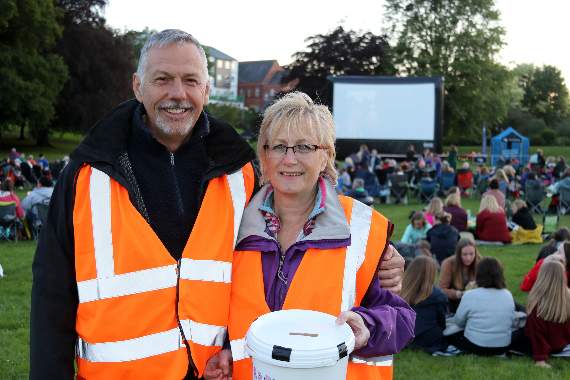 John and Chris Downes helping collect donations before the film started. AQ 1848