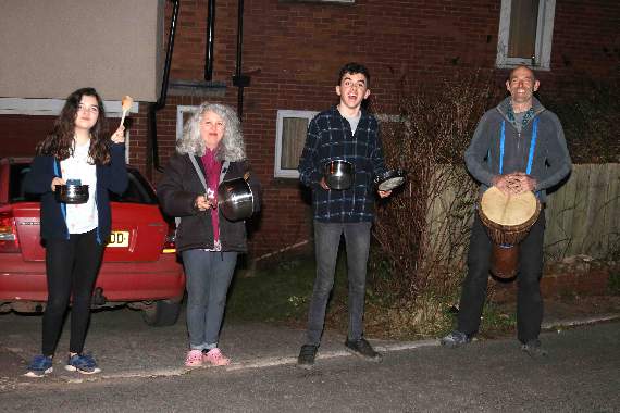 Dee Saunders, second left, and family led the bashing of pots, pans, drums and applause at George Hill, Crediton. AQ 7233