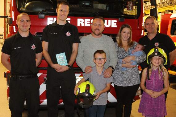 Crediton firefighters Rory Fleming, second left and Mark Bolt, right, who helped with the delivery of a baby boy during a co-responder call-out met up again with the mother, Layla second right with her new arrival, Thomas, and rest of the family, husband Allan and their other children Eve and Harry at Crediton Fire Station this week. Left is Crediton Station Watch Manager Neil Hargreaves, who praised the firefighters. AQ 4553