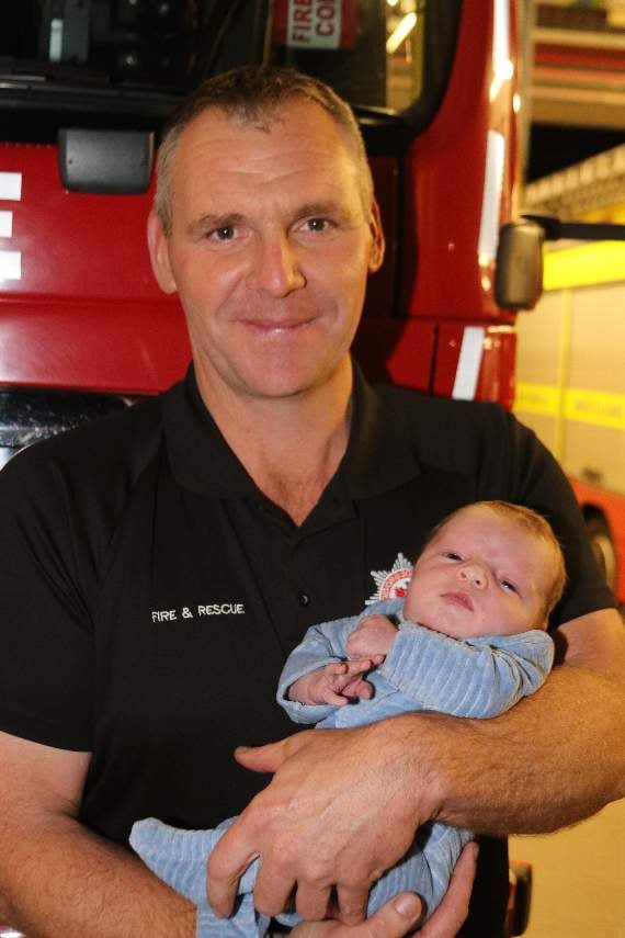 Crediton firefighter Mark Bolt with baby Thomas Broome whom he helped deliver during a co-responder call-out. AQ 4561