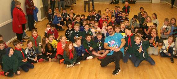 Most of the Cubs sit for a group photo with magician T J. SR 2884