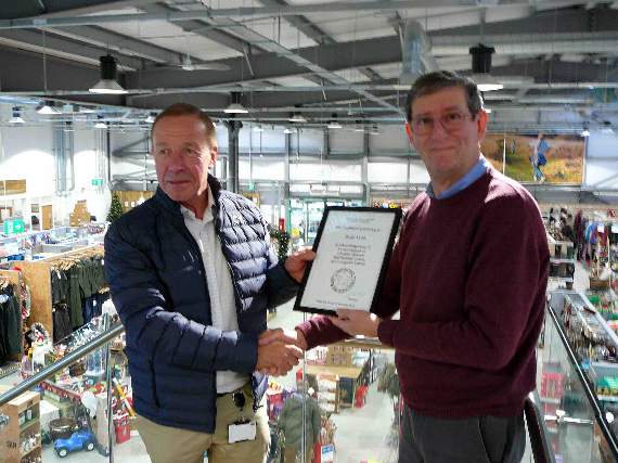 Chairman of Crediton Area History and Museum Society chairman, John Heal presented John Lee with a certificate at Mole Avon Country Stores in Crediton.