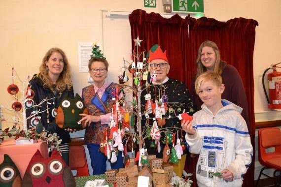 Pictured behind the Newton St Cyres School Craft Group stall is right Pippa Johnson with her sister Nicola, left, with Tony and Wendy Hough, helpers and a young customer.