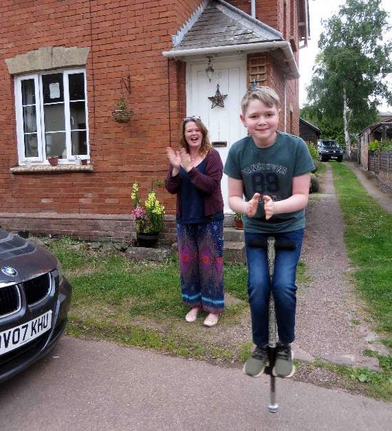 One young resident managing to clap while jumping on his pogo stick.
