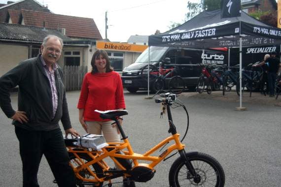 Mike Sanders of The Bike Shed with Kath Bowen who runs the cycling courses; with them is the electric bike that will pack to a third of its volume, is the same length as an ordinary bike and can take two children on the back, carry a load up to 180kg, be ridden by riders up to 6’5” and so caters for all the family; with hydraulic brakes and 155 mile range, a great solution for many. SR 1443