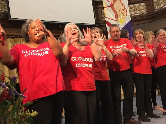Glorious Chorus with hand actions during a performance.