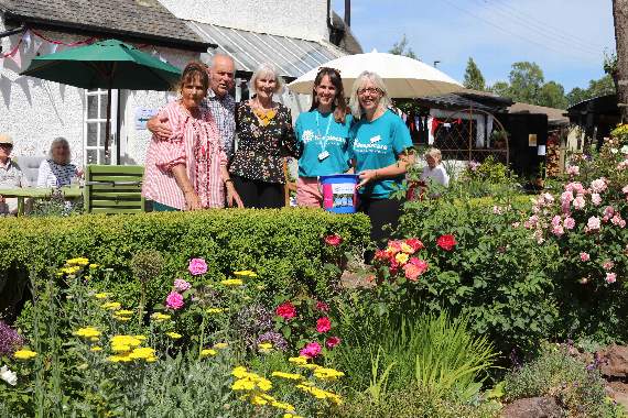 Open Garden hosts Miranda and Roger Olver, left, with helper Naomi Johns and Hospiscare representatives Ali McGeown and Denise Hook. AQ 1575