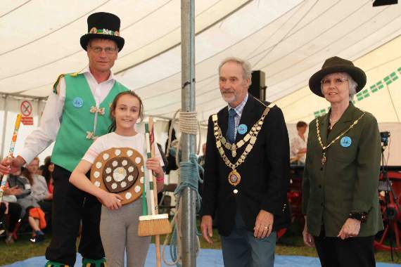 Broom dance competition winner Stephanie Lowe (10), receiving her awards from the Mayor of West Devon, Cllr Tony Leech, left, Exeter Morris Man Mike Long and Mayoress, Mrs Sue Leech.