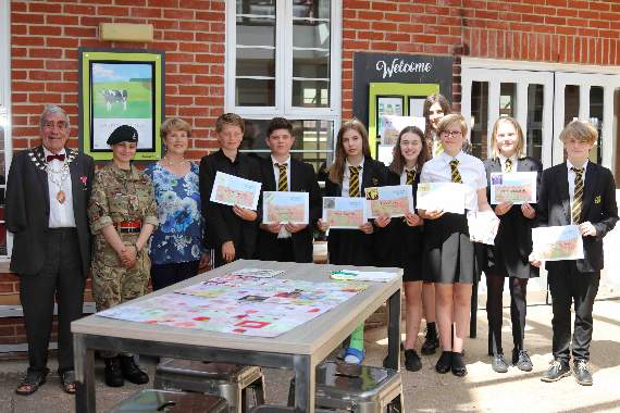 From left, The Mayor of Crediton, Cllr Frank Letch, the Mayor’s Cadet, Lance Corporal Sammy Pleece-Drake and Mayoress Mrs Natalia Letch with the QE students presented with certificates following their Reflect and Remembrance Post-it-Note Art Show. AQ 1724