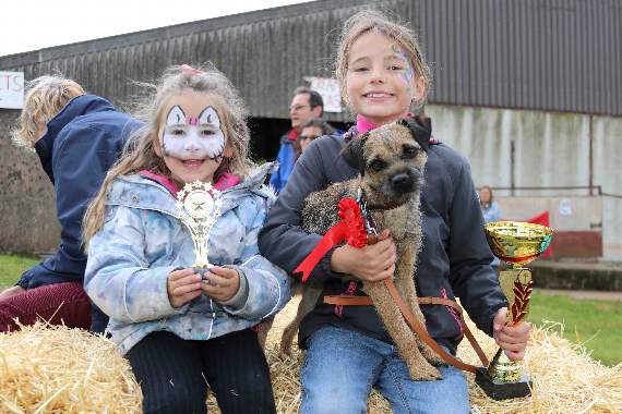 Neve Webber (9), right, of Jacobstowe, won the Child Handler Champion class and class handler class with Border Terrier, Lottie, pictured with Zola Webber (5), and the trophies received. AQ 2057