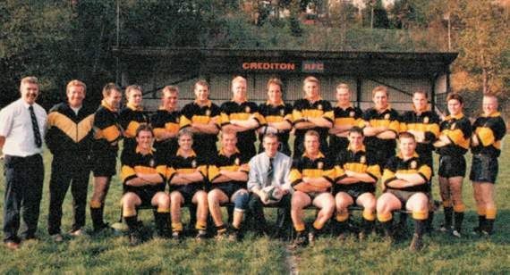 Crediton RFC First XV in 1997-98, the Runners-up in the Cornwall and Devon League; Standing from left, Paul Harris (Admin), Eddie Trick (Coach), Alec Scheepers (not paying attention!), Paul Crocker, Alan Lovell, Ben Blackburn, Jay Harris, Alan Westcott, Sam Fice, Mark Binks, Richard Daw, Simon Grainger, Leon Sheen and Matt Chiverton; Seated: Jim Kendrew, Stuart Crocker, John Leyman, Graham Carter (Captain),Toby Newstead, Shane Bayley and Chris Kibbey.