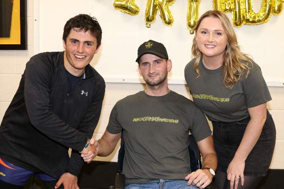 Guy Hamer, left, is welcomed to North Tawton Rugby Club and thanked by Craig Dennis and his wife Chloe. AQ 4247