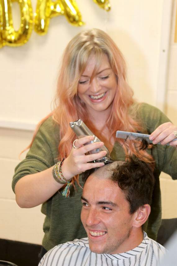 Matt Baker having his head shaved by hairdresser Louise Browne. AQ 4278