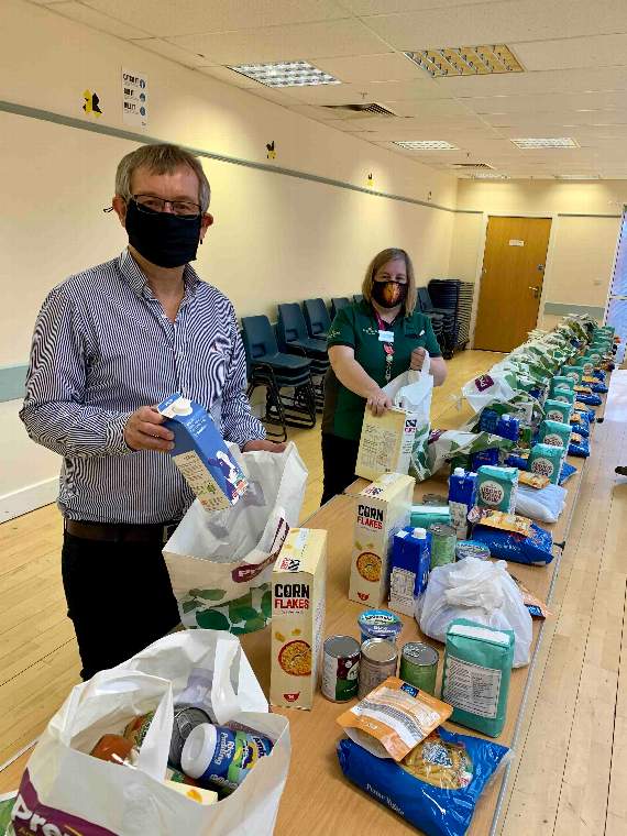 Alan Quick and Sharon Arnold, Crediton Morrisons Community Champion packing food parcels at Inclusive Exeter.