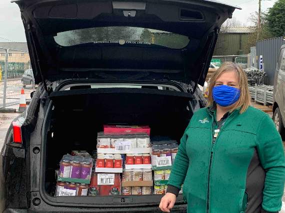 Sharon Arnold with food items donated by Morrisons for food parcels.