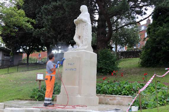 The specialist engineer during the cleaning process of the St Boniface Statue. AQ 8365