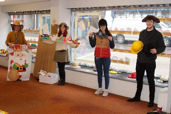 With some of the Hattastic competition entries and others used to decorate the shop window at the former Town and Countrywear Shop, from left, Lisa Blake, Steph Jones and from Mole Avon, Lauren Cook and Ted Elson. AQ 9693
