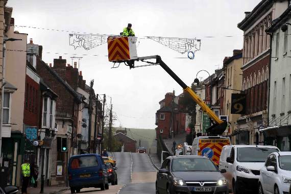 The cross-street Christmas decorations being put up recently in Crediton High Street. AQ 9553
