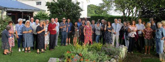 Volunteers gathered in the garden of the Tom Cobley to celebrate 10 years (plus one) of Spreyton Village Shop.