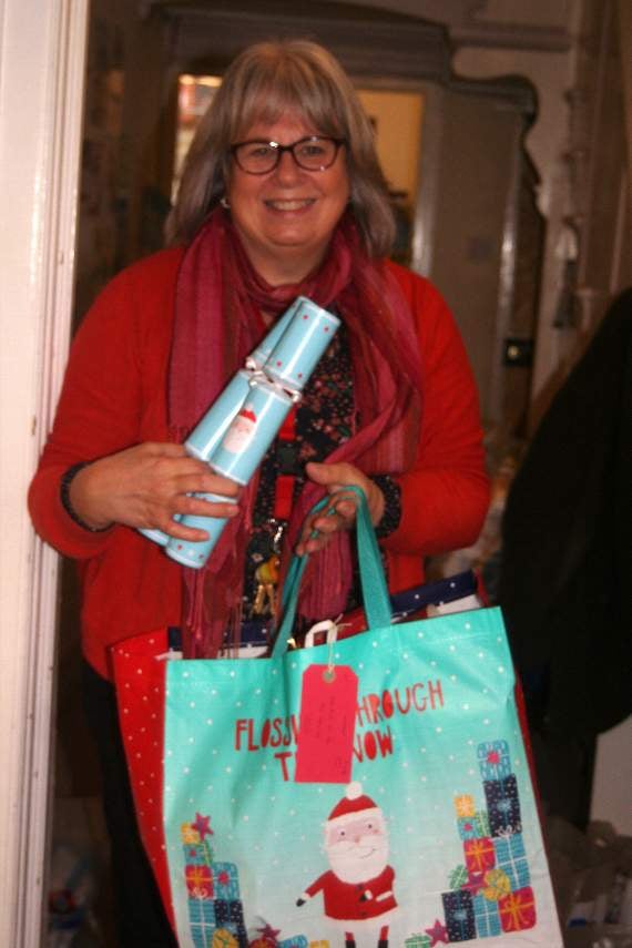 Chris Parsons and one of the bags of Christmas goodies going out from the Foodbank at Crediton. 3444