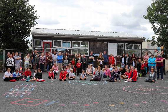 At the protest against government inaction at Lapford Primary School on Friday, children, parents, staff and village representatives in front of the condemned classroom. AQ 8374