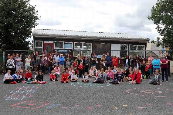 At the protest against government inaction at Lapford Primary School on Friday, children, parents, staff and village representatives in front of the condemned classroom. AQ 8374