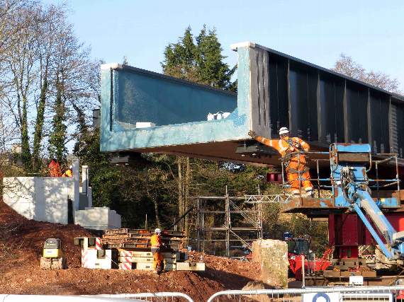 Giving the bridge a bit of a shove, men on the new abutments waiting to receive it. The bridge is 11.5ft wide. 1385