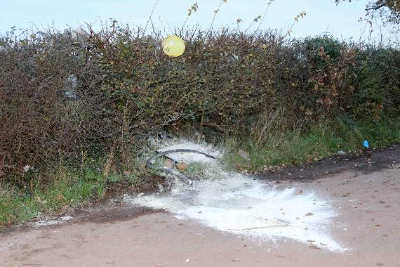 The waste paint or whitewash in the lay-by and hedge. AQ 9793