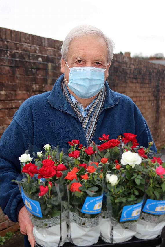 Lion Peter Bryan with some of the flowers donated to Age Concern Crediton. AQ 0367