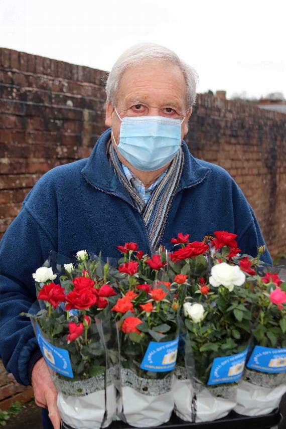 Lion Peter Bryan with some of the flowers donated to Age Concern Crediton. AQ 0367