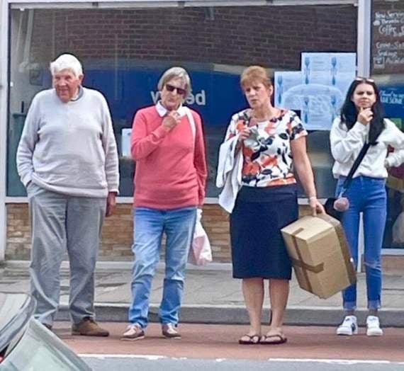 Members of the community pondering on how best to catch the baby rabbit.