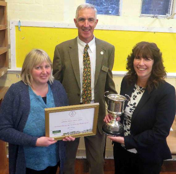 For Landscore, teaching assistant Penny Powlesland and headteacher Debbie May with cup and Tony Moore. SR 0533