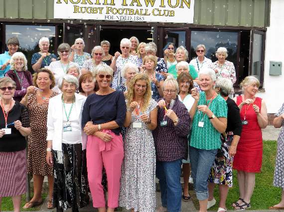 Members on the steps outside the Rugby Club creating a cloud of bubbles. SR 1996