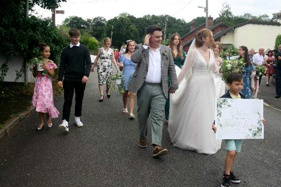 The newly-wed Mr and Mrs Ford walking to the village pub, The Duck, for their reception. SR 4190