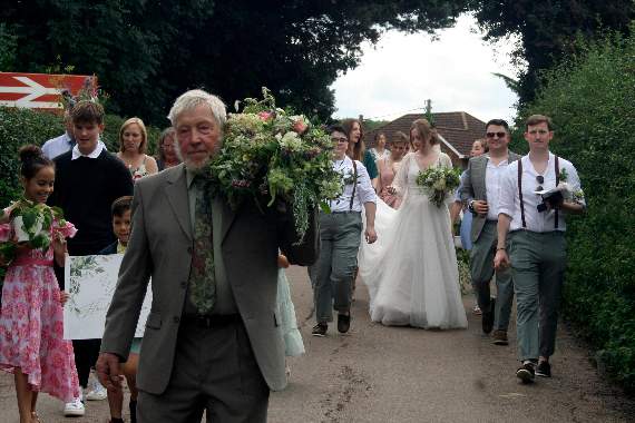 Carrying a floral arrangement from the altar on his shoulder followed by the rest of the wedding party crossing the railway bridge at Yeoford. SR 4194