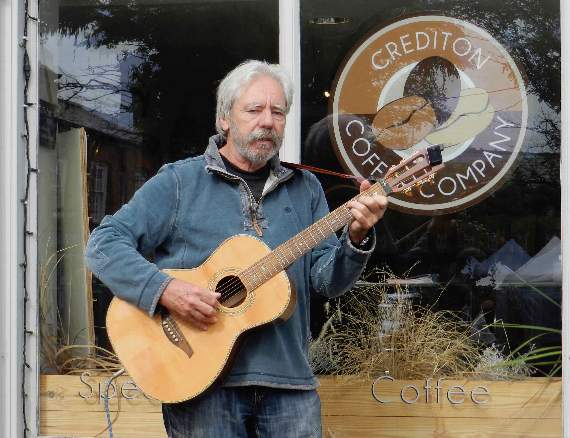 Alistair Toms from Shobrooke busking outside Crediton Coffee Shop. NP 210821 01