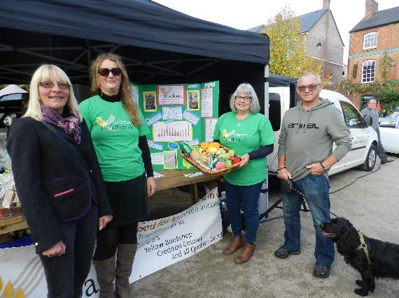 On the Crediton Foodbank stall, from left, Karena Marshall (volunteer), Sarah Beverley (Co-ordinator), Chris Parsons (Trustee) and volunteer, Richard Partridge with Alfie. NP 091021 11