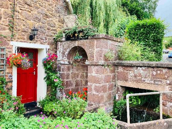 The side of Shute Cottage, winner of the hanging basket and window box section in this year’s Sandford Gardens competition. Photo: Carol Furze