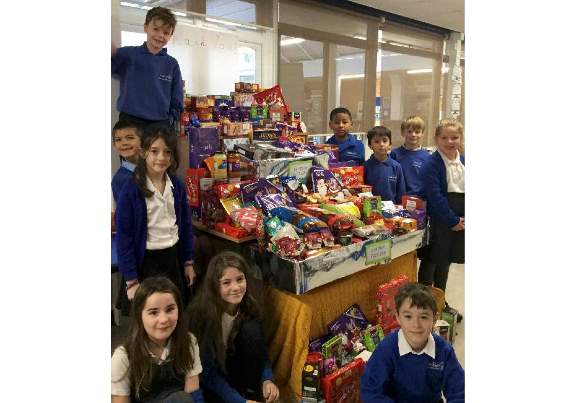 Children from Landscore Primary School with the food for Crediton Foodbank.