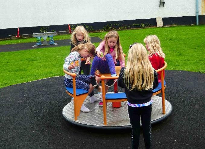 Children enjoying the roundabout.
