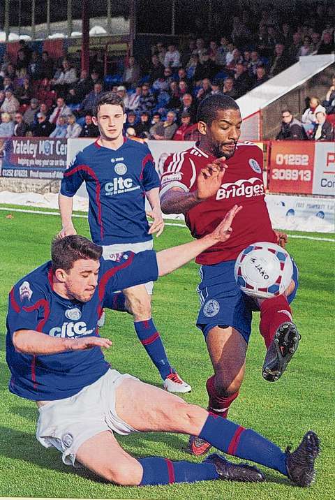 Josh Scott tries to keep possession as Josh Brizell comes sliding in for Hyde. PICTURE: ERIC MARSH