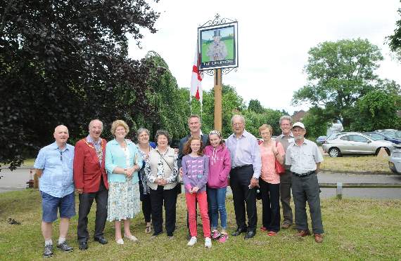 Graham Thorpe and daughters in the centre with John Birch (4th from right), project director, and some of the people who supported the mission to bring the pub sign back to Wrecclesham (Order no FD27-581-16)