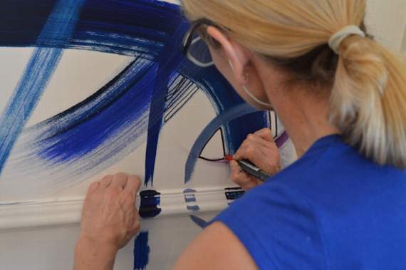 Alison draws in a black line