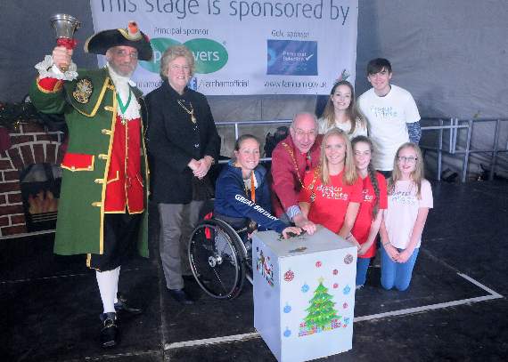 <p>Farnham's past town crier Jonathan Jones (left) with Paralympian Rachel Morris, the then-mayor and mayoress of Farnham, John and Gillian Ward, and cast members of pantomime Snow White  switch on the town's Christmas lights</p>