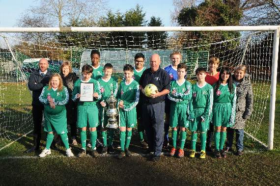 Students in their new kit with headteacher Nathan Aspinall, Patsy Walker, charity founders Gordon and Ann Parris and Pauline Way