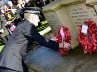 A Surrey Police officer lays a wreath during the Remembrance Sunday parade at Haslemere War Memorial in the High Syreet.