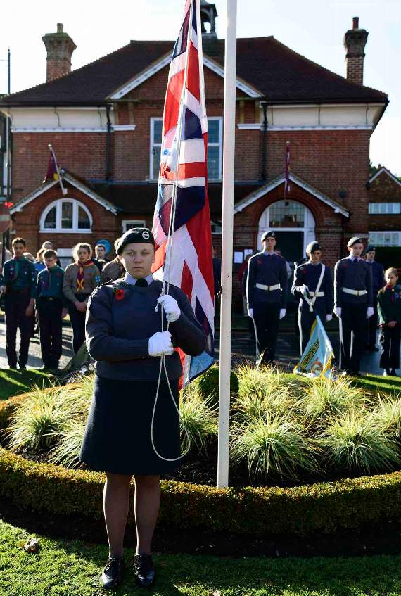A Haslemere Air Cadet lowers the Union Flag during the service at the War Memorial