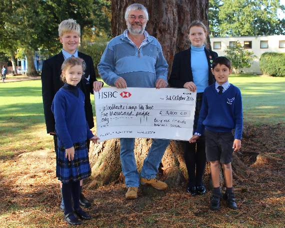 Nick Richards receives the cheque from Barfield pupils