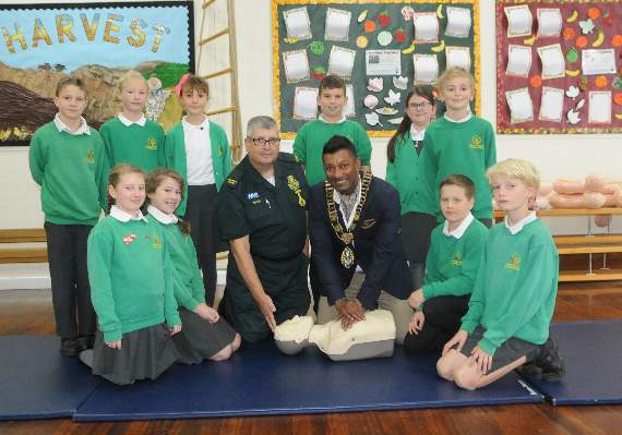 Haslemere mayor Sahran Abeysundara learns how to do CPR on one of the dummies during the Restart a Heart demonstration